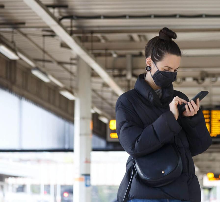 Commuter on her phone at a train station