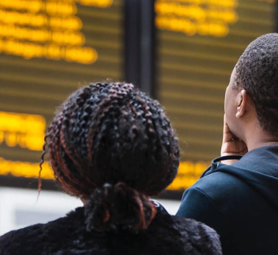 Couple looking at train times
